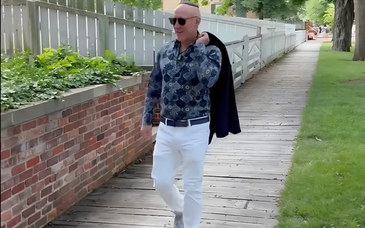 Edwards in white pants and button down shirt walking along Chicago sidewalk