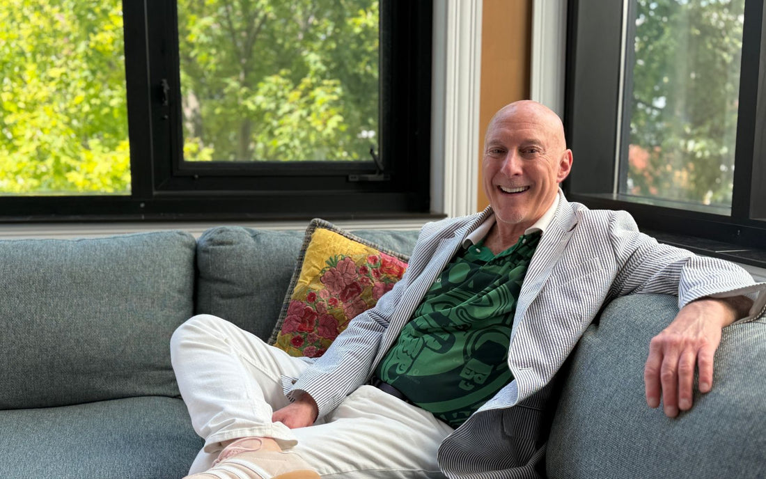 Edwards Buice, men's style expert, shown wearing a blazer and green shirt sitting in his Chicago Color Analysis studio