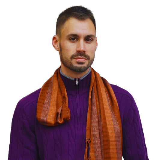 Bold and bright men's scarf shown on model wearing purple sweater