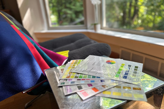 Color swatch books on a table with a window in the background